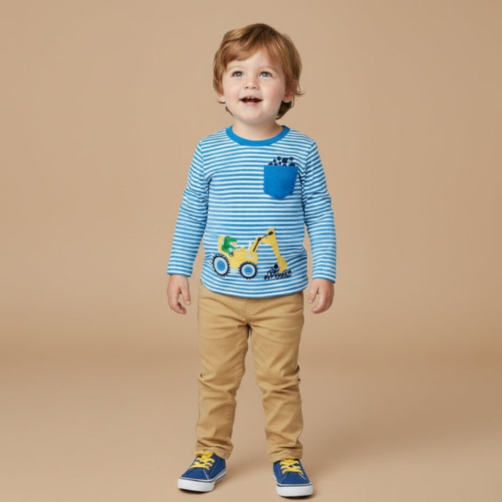 Child wearing a blue striped shirt with a truck design on a beige background
