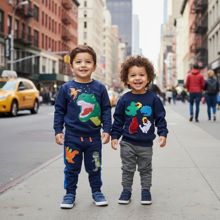 Two children in colorful sweaters with animal designs standing on a city street.